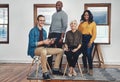 When we put our minds together we can do anything. Portrait of a group of confident businesspeople seated together Royalty Free Stock Photo