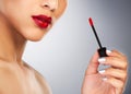 Put on some red lipstick and pull yourself together. an unrecognizable woman applying red lipstick to her lips. Royalty Free Stock Photo