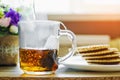 Put the tea bag in a transparent glass in a cup and pour boiling water over it Royalty Free Stock Photo