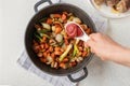 Put tomato paste in a sauce pan with chopped and roasted vegetables for making sauce or gravy. Royalty Free Stock Photo