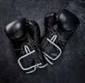 Put your hands up. High angle shot of a pair of boxing gloves placed together on top of a dark background inside of a Royalty Free Stock Photo