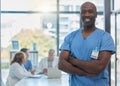 Put your trust in people who care. Cropped portrait of a handsome young male nurse standing in the hospital boardroom Royalty Free Stock Photo