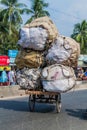 PUTHIA, BANGLADESH - NOVEMBER 10, 2016: Overloaded rickshaw on a road in Puthia, Banglade