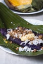 Puto bumbong or purple rice cake with grated coconut and margarine