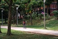 Jogging track with beautiful trees near residential area with child riding bicycle in motion Royalty Free Stock Photo