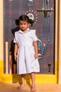 PUTTAPARTHI, ANDHRA PRADESH, INDIA - JULY 9, 2017: Cute Indian girl in white dress. Vertical. Copy space for text.