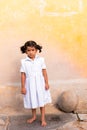 PUTTAPARTHI, ANDHRA PRADESH, INDIA - JULY 9, 2017: Cute Indian girl in white dress. Vertical. Copy space for text.