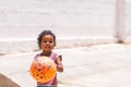 PUTTAPARTHI, ANDHRA PRADESH, INDIA - JULY 9, 2017: Happy indian girl playing on the street. Copy space for text.