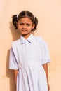 PUTTAPARTHI, ANDHRA PRADESH, INDIA - JULY 9, 2017: Portrait of a cute indian girl in white dress. Close-up. Vertical.