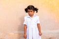 PUTTAPARTHI, ANDHRA PRADESH, INDIA - JULY 9, 2017: Portrait of a cute indian girl in white dress. Copy space for text.