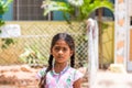 PUTTAPARTHI, ANDHRA PRADESH, INDIA - JULY 9, 2017: Portrait of Indian cute girl on the street. Close-up. Copy space for text.