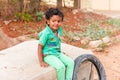 PUTTAPARTHI, ANDHRA PRADESH, INDIA - JULY 9, 2017: Portrait of Indian cute girl on the street. Copy space for text.