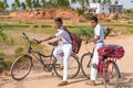 PUTTAPARTHI, ANDHRA PRADESH, INDIA - JULY 9, 2017: Two Indian boys on bicycles. Copy space for text.