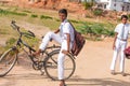 PUTTAPARTHI, ANDHRA PRADESH, INDIA - JULY 9, 2017: Two Indian boys on bicycles. Copy space for text.