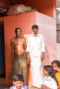 PUTTAPARTHI, ANDHRA PRADESH, INDIA - JULY 9, 2017: Two Indian men and children. Copy space for text. Vertical. Royalty Free Stock Photo