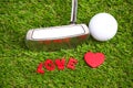 Putter and golf ball on green background Royalty Free Stock Photo