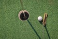 Putter with golf ball and hole Royalty Free Stock Photo