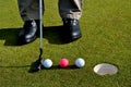 Putter and three golf balls Royalty Free Stock Photo