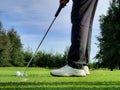 Hit the ball on the grass with a golf club Royalty Free Stock Photo