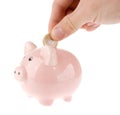 Putting coin into piggy bank isolated Royalty Free Stock Photo