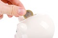 Putting coin into piggy bank isolated Royalty Free Stock Photo