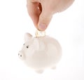 Putting coin into piggy bank isolated Royalty Free Stock Photo