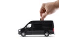 Putting coin into the transport black van car Royalty Free Stock Photo