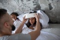 Caring father putting cold towel on forehead of daughter