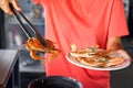 Putting cooked blue crab on white plate Royalty Free Stock Photo