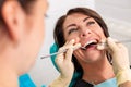 Putting dental braces to the woman`s teeth at the dental office. Dentist examine female patient with braces in dental Royalty Free Stock Photo
