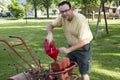 Putting Gas In A Old Garden Tiller Royalty Free Stock Photo