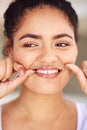 Putting great care into her beautiful smile. a young woman flossing her teeth in the bathroom. Royalty Free Stock Photo