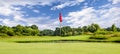 Putting green with a flag at a golf course on a summer day Royalty Free Stock Photo