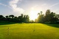 Putting green on golf course to practice the putter golf shot. Training area with many holes with flags Royalty Free Stock Photo