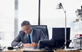 Putting the hard yards in. A senior businessman working hard at his desk. Royalty Free Stock Photo