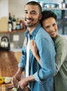 Putting a healthy dash of love in thier cooking. Portrait of an affectionate young couple preparing a meal together in Royalty Free Stock Photo