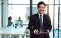 Putting his business online. a handsome young businessman using a tablet in the workplace. Royalty Free Stock Photo