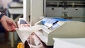 Woman is laminating paper in laminating machine laminator in typography. Royalty Free Stock Photo