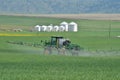 Putting liquid fertilizer on crop field.