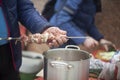 Putting meat on knife. Cooking meat with your hands. Street food. Folk Caucasian cuisine Royalty Free Stock Photo