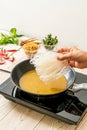 putting noodle on pan with sauce Royalty Free Stock Photo