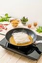 putting noodle on pan with sauce Royalty Free Stock Photo