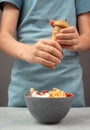 Putting pepper in a pasta salad, sliced mushroom, tomato, red pepper pieces and tuna, healthy food with vegetables, fresh organic Royalty Free Stock Photo