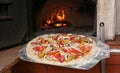 Putting pizza into oven in kitchen Royalty Free Stock Photo