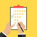 Putting the rating on paper. Hands hold a paper and put a rating of three stars.