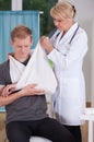 Putting on sling to patient's hand Royalty Free Stock Photo