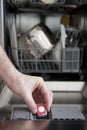 Putting tab into dishwasher