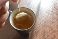 Putting a tea bag in hot water into a tea cup. Royalty Free Stock Photo