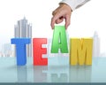 Putting A in for TEAM on glass table Royalty Free Stock Photo