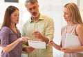 Putting their heads together. Shot of three business professionals standing and going through some paperwork together. Royalty Free Stock Photo